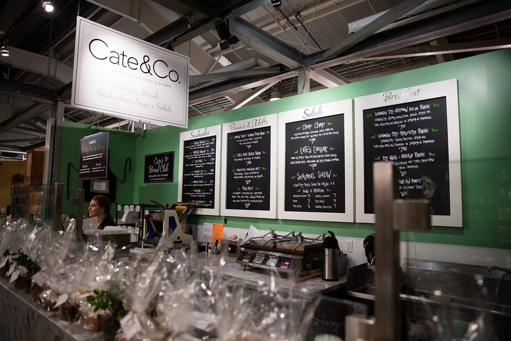 Row of illuminated menu boards mounted above a serving counter