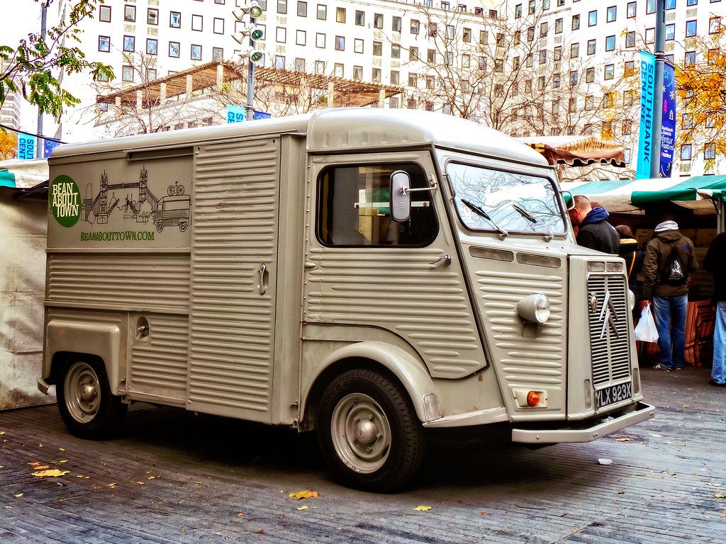 Street food van serving customers at a busy outdoor market